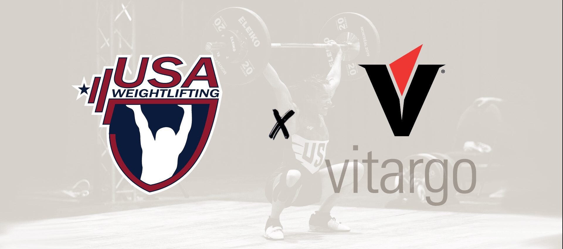 A man lifting some weight in front of the usa weightlifting logo.