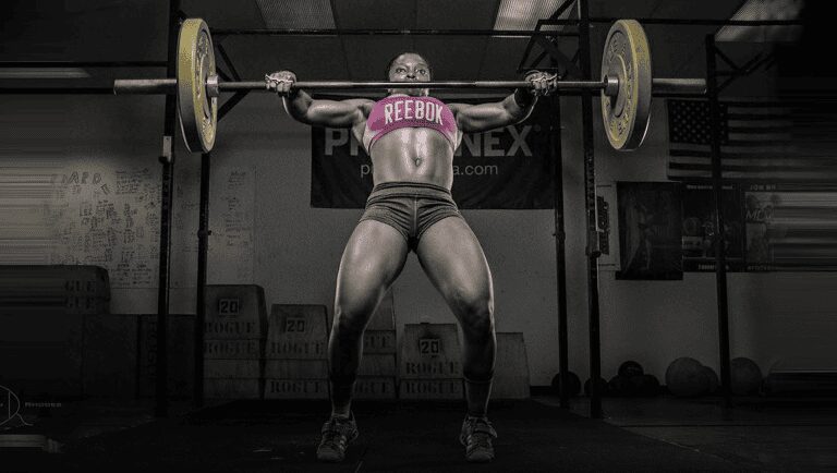 Female athlete lifting a loaded barbell